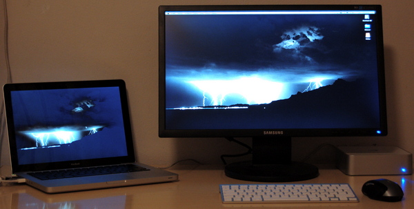 My desk: a MacBook, a SyncMaster and an Apple Wireless Keyboard`